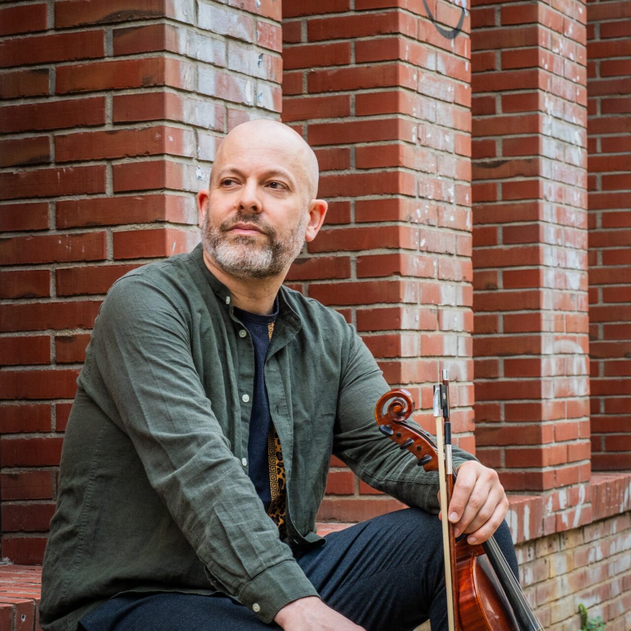 Roland Satterwhite sitting with his violin.